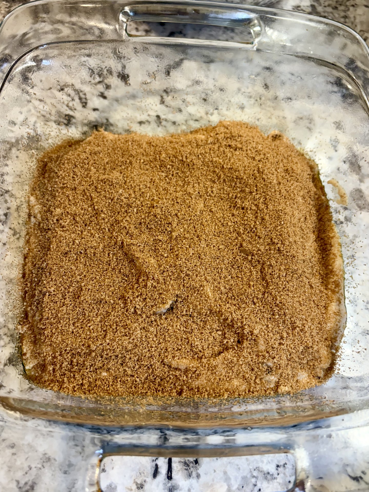 Cinnamon brown sugar ribbon covering the first batter layer edge to edge in the glass dish
